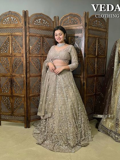A full-length shot of the elegant beige lehenga, showcasing its graceful silhouette and the beautiful way the embroidered skirt falls.