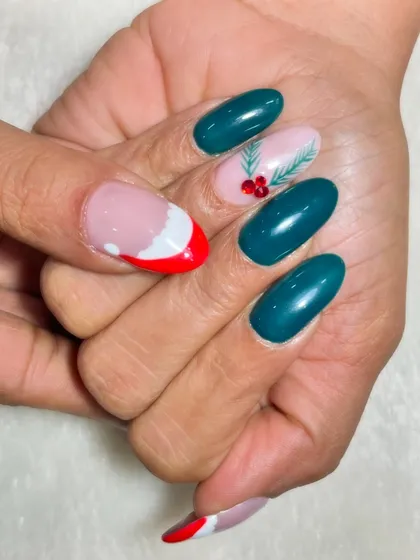 The full look of the teal and Santa hat Christmas nails. The combination of colors is unexpected yet perfectly festive, offering a modern twist on holiday nail art.