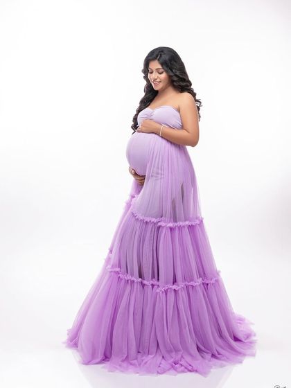 A soft and romantic portrait in a beautiful lavender ruffled gown. The sheer, tiered fabric adds a touch of whimsy and grace.