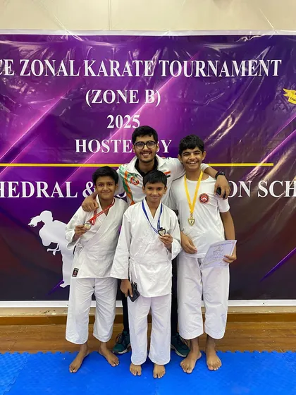 Celebrating our Zonal champions. Three of our students proudly pose with their medals and their coach after a successful day at the ICSE Zonal Karate Tournament, where all five of our participants medaled.