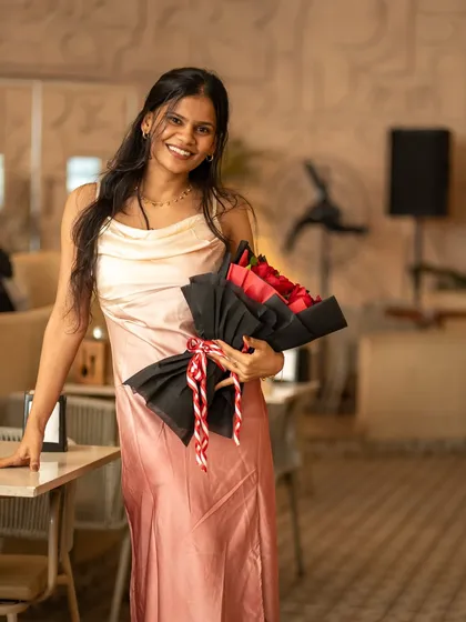 A guest celebrating with a bouquet of roses. My parties are a place for joy and celebration.