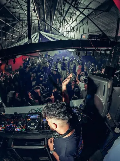 A fisheye view from the DJ booth, capturing the entire club in one frame. This perspective shows the scale of the party and my central role in it.