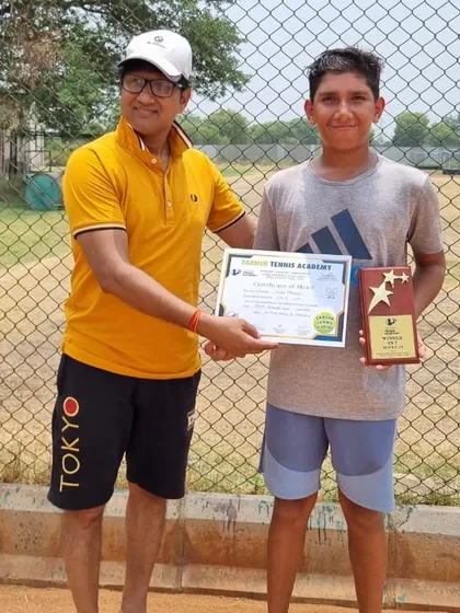 Anay Pandey receives his winner's plaque for the Under-14 Boys category at the Championship Series Tournament in Sonepat.