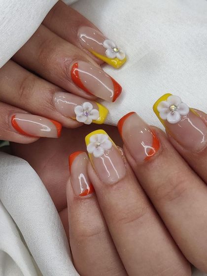 A close-up showcasing the detail of the 3D flower embellishments on this bright and cheerful nail set.