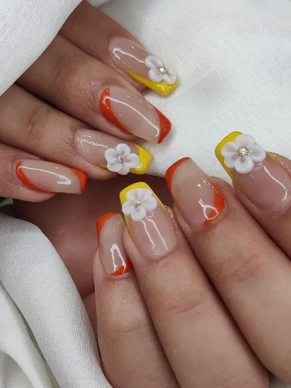 A close-up of the 3D floral French manicure, showing the detail of the sculpted flowers.