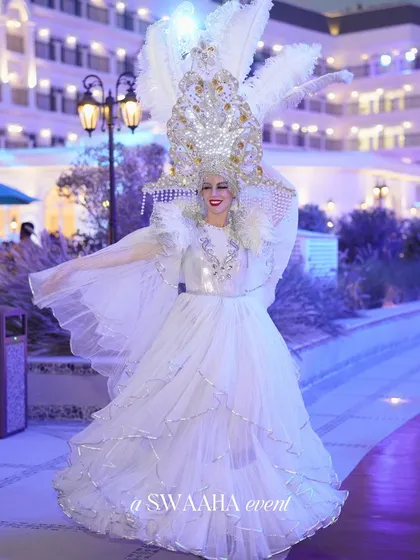 The same angelic performer, captured in a moment of graceful welcome, showcasing the high-quality, costumed entertainers I source for events.