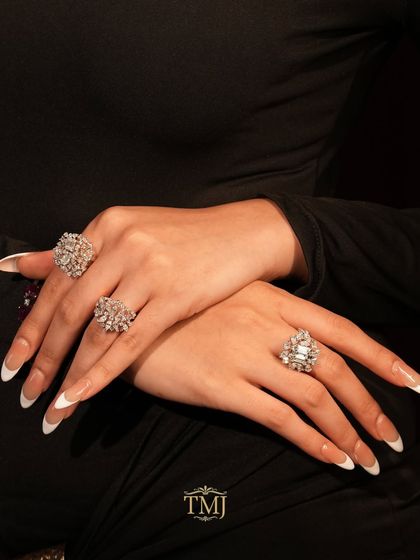 A closer look at our stunning diamond cocktail rings, worn to create a balanced and brilliant hand stack. Each ring features a unique cluster of diamonds for maximum impact.