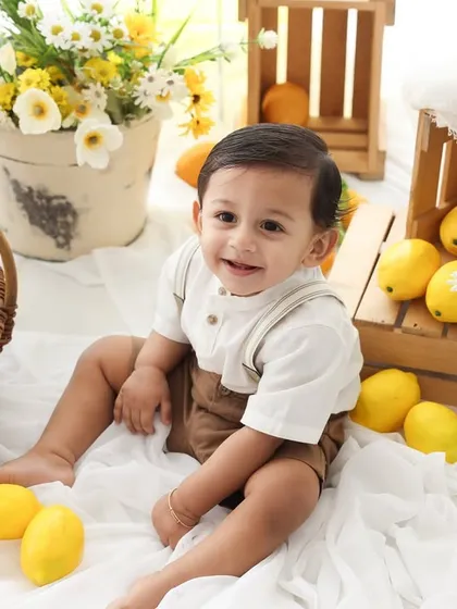 Surrounded by sunshine. This happy baby is right at home in our lemon garden setup. The bright yellows and natural wood textures create a warm and inviting atmosphere.