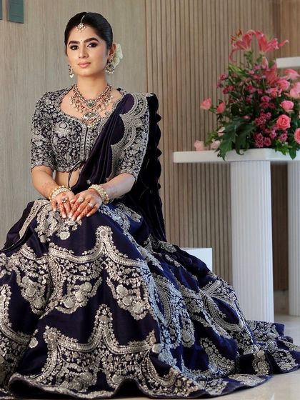 A seated portrait showing the grandeur of the outfit and the elegance of the makeup and hair.