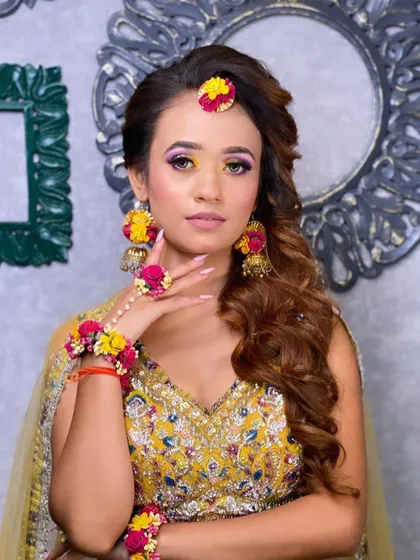 A portrait of the client, showing how the vibrant eye makeup and floral jewellery come together for a perfect Haldi look.