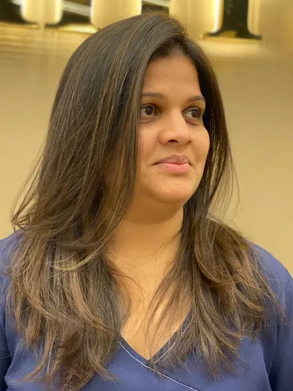 A side view of a client's layered haircut, showcasing the movement and texture of the style.