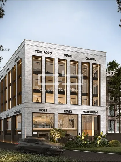 This commercial facade is an example of contemporary architecture with modern materials. Expansive glass fenestrations offer transparency, while sleek cladding and bold branding for luxury retailers create a refined and upscale look.
