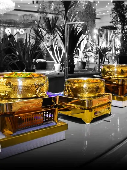 A black-and-white shot with a pop of gold, highlighting our luxurious buffet serveware. This artistic image emphasizes our belief in discovering a new dimension of catering through opulence and refinement.
