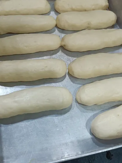 These are my brioche buns, proofing and ready for the oven. A good bake starts with a good dough, and I take my time to make sure it's perfect before it becomes the base for my veggie sausage buns.