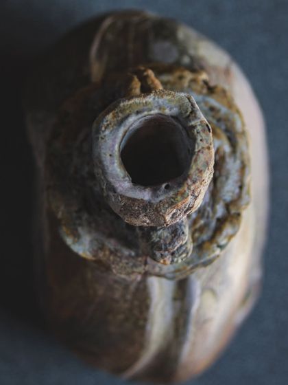 A top-down view of a wood-fired bottle form, revealing the textures created by the flame's path. The process is a collaboration between my hands and the fire, resulting in a truly unique sculptural object.