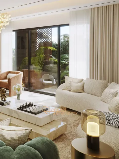 This view highlights the connection to the outdoors, with a large glass door leading to a green patio. The layered coffee tables and curved sofa create a dynamic and engaging living area.