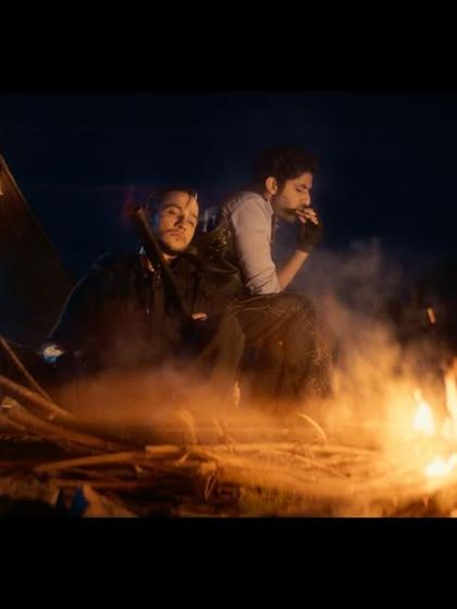 A moody campfire scene from the Freefire ad. The styling involved rugged, dark-toned outfits with modern accessories like fingerless gloves to create a contemporary action look.