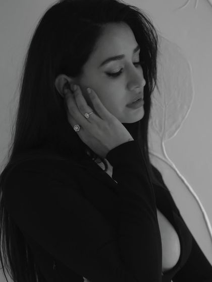A soft, pensive moment from the 'Gustaakh Ishq' video. The black and white photography beautifully captures the mood and the subtle details of the makeup.