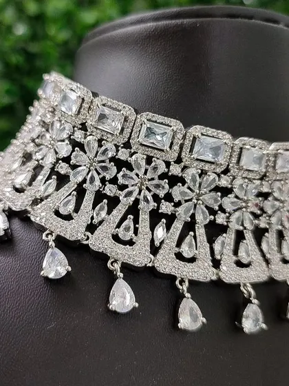 A close-up of the necklace, highlighting the pattern of square and teardrop-shaped stones that give it so much brilliance.
