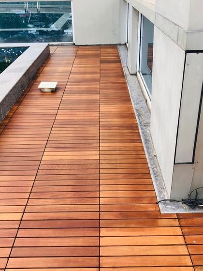 A close-up view of the IPE wood deck tiles. You can see the rich color variation and tight grain that make this wood so sought after for luxury outdoor flooring.