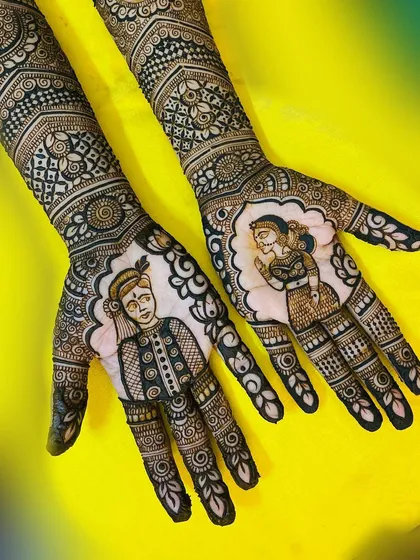 This design features classic bride and groom portraits, each framed beautifully on the palm. It's a timeless way to celebrate your union through traditional henna art.