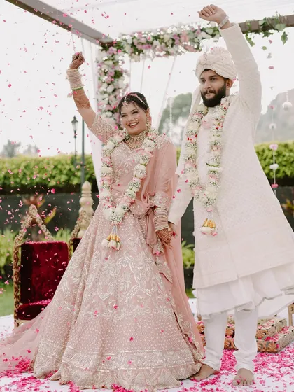 Hands in the air, celebrating their union! This shot is full of energy and captures the festive spirit of the wedding.