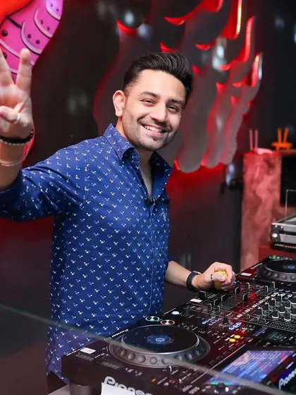 All smiles and a peace sign from the DJ booth.