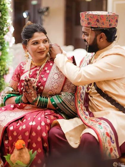 A candid moment during the wedding ceremony. The bride's makeup looks flawless even in the midst of the rituals.