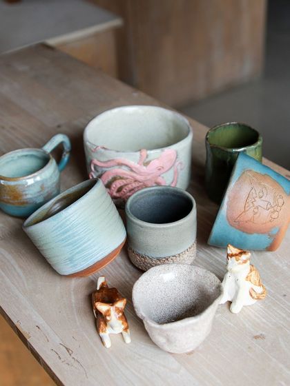 A whimsical collection featuring an octopus bowl, cat figurines, and other imaginative pieces that showcase the playful side of our students' creativity.