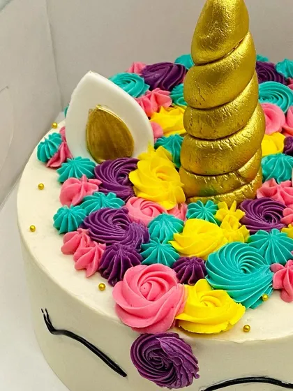 A close-up of the colorful buttercream swirls that make up the unicorn's mane.