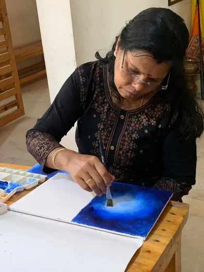 A student practices a background wash in acrylics. Mastering this technique is crucial for creating a finished and professional-looking artwork.