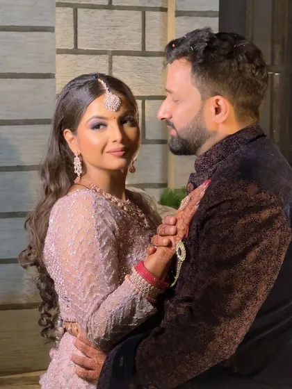 A romantic couple shot. The bride's glamorous makeup looks perfect next to her partner, creating a picture-perfect memory.