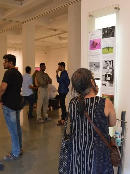 Visitors reading the curatorial note and artist statement at the entrance of the exhibition.