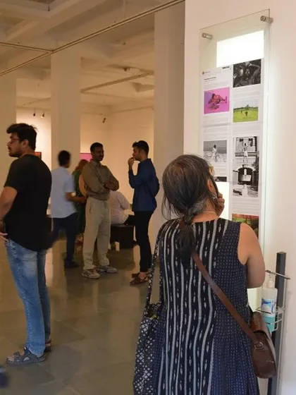 Visitors reading the curatorial note and artist statement at the entrance of the exhibition.