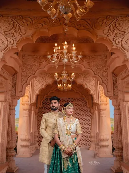Another beautiful portrait framed by the palace arches. The lighting from the chandeliers adds a warm, romantic glow to this elegant couple shot.