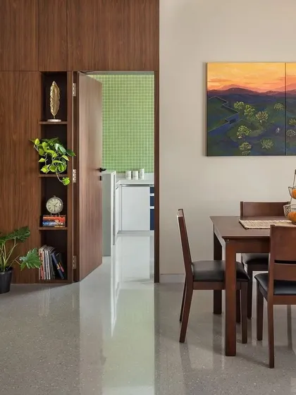 A peek from the dining area into the kitchen. We designed the layout to feel connected but distinct, with warm wood tones in the dining room leading to a bright, functional kitchen space.