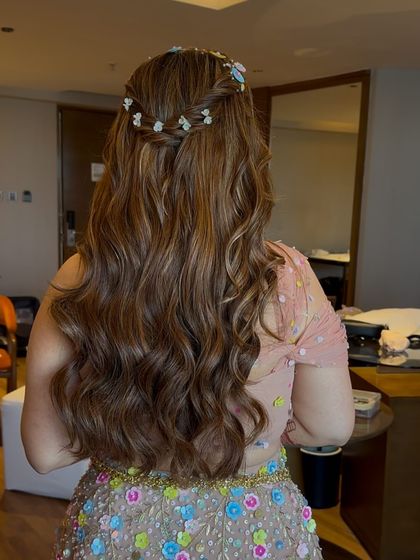 The complete look, showing how the soft, wavy hairstyle complements the dreamy, embellished gown.