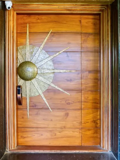I believe in the power of craftsmanship. This oversized main door, made from FSC certified teak wood with a custom brass sun-themed handle, serves as a grand, artistic statement, setting a tone of bespoke quality from the very first touch.