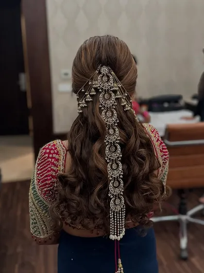 A still shot of the ornate Mehndi hairstyle, showing the beautiful jhumka details on the accessory.