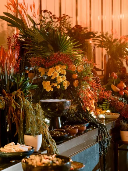 I design grazing tables that are edible landscapes. Here, a cascade of florals, fruits, and foliage merges with curated platters, creating a multi-sensory experience where food becomes part of the art.