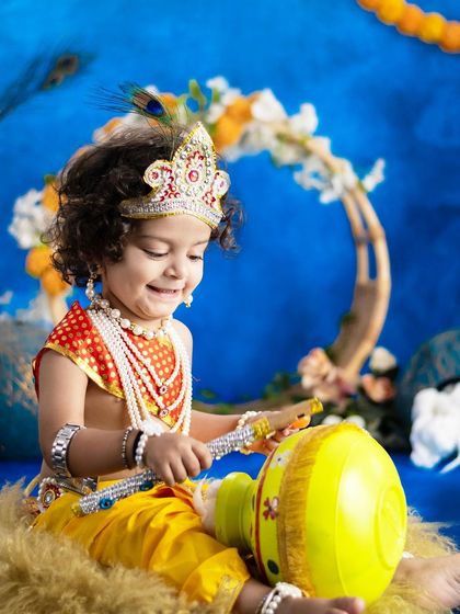 A joyful Krishna playing with his pot of butter. We capture the playful spirit of the theme.