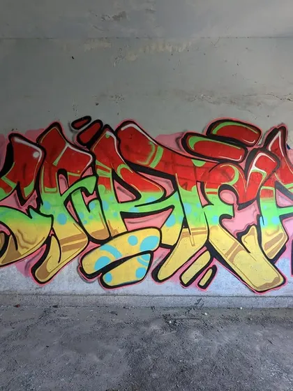 A straight-on shot of the 'Red Gold & Green' piece, showing the full composition and the tags of the crew.