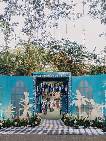 The grand facade and entrance for the Bar Palladio-inspired Haldi. The entire structure was designed with custom-cut panels and handcrafted flowers to create a stunning first impression.