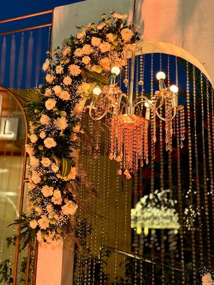 The floral and chandelier detail against the night sky, creating a romantic and enchanting visual.