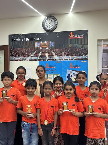 A group of our students with their teacher, holding up their awards. Team spirit and mutual encouragement are a big part of our classroom culture.