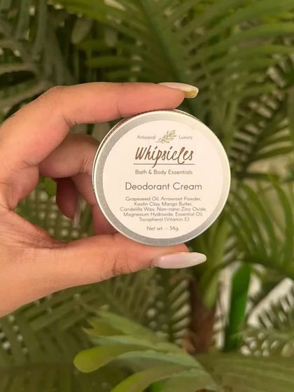 A hand holding our Deodorant Cream. We offer it in woody and citrus fragrances, scented only with natural essential oils.