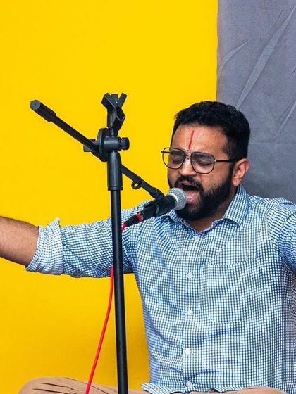 A musician leading the chants with heartfelt devotion during a Bhakti Immersion session. These events are led by experienced kirtan artists.