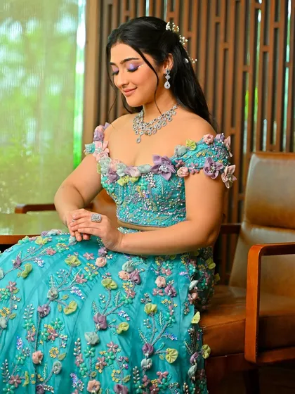 The full view of this magical, floral-themed look. The off-the-shoulder gown is a work of art, and the makeup and hair are designed to complement it perfectly.