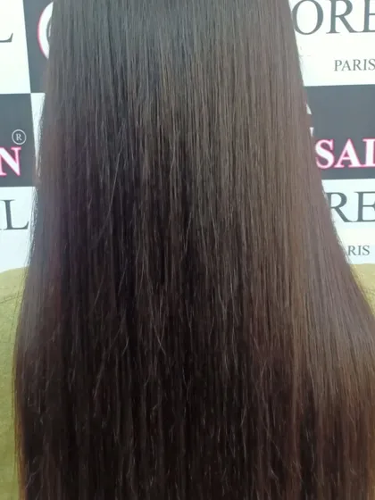 A close-up look at the texture of hair after a straightening service. Notice the smooth, frizz-free finish from root to tip.