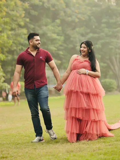 A joyful, walking shot of the couple. This photo captures the happiness and anticipation of their journey into parenthood.